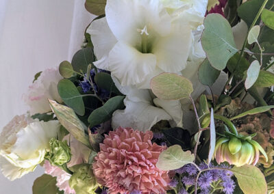 White and pastel flowers in a vase.