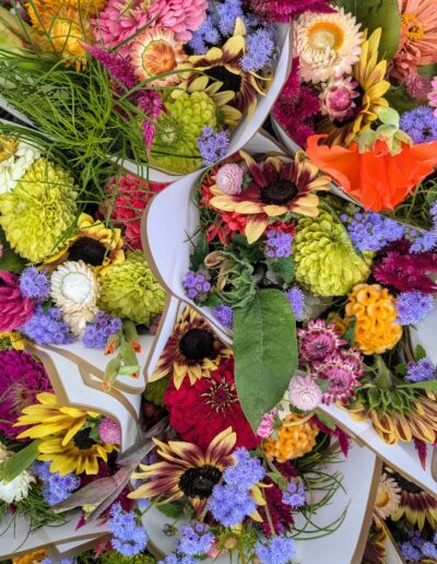 Multiple flower bouquets with vibrantly colored blooms.